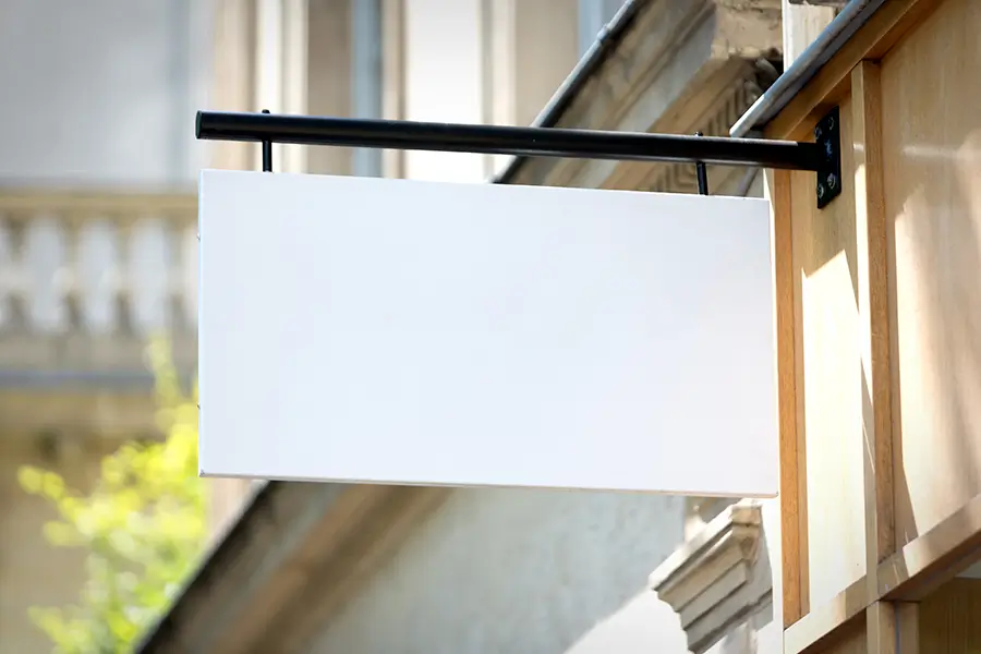 Blank front store sign hanging from the wall