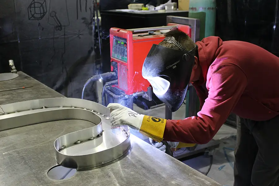 Technician wielding a steel store sign