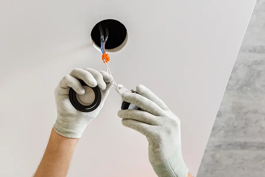 Technician working on a retrofit LED light