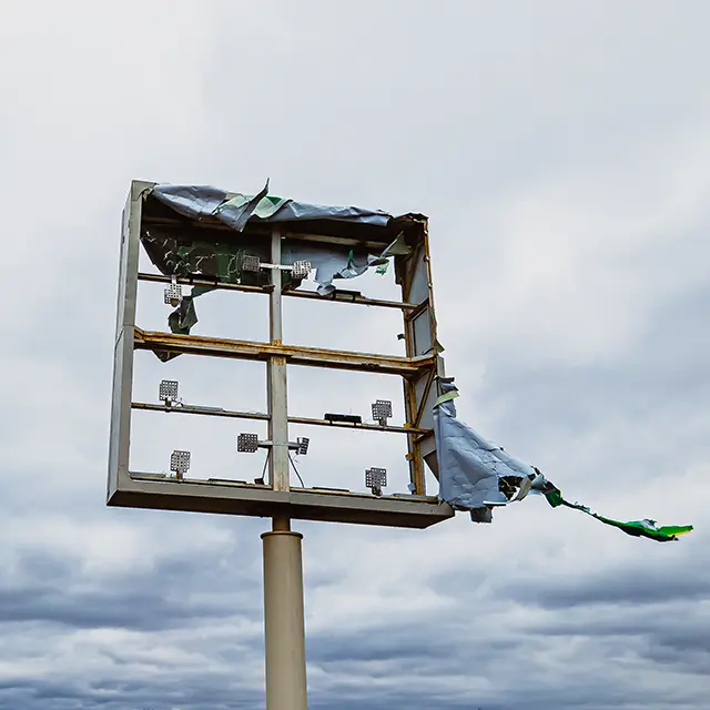 Broken sign after storm in the wind